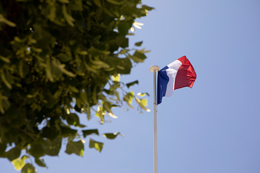 The French tricolour on a flagpole in Paris