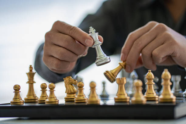 istock Businessman moving chess pieces on chess board game ideas for ideas and competitions and strategies, success, business competition planning ideas. 1407258534