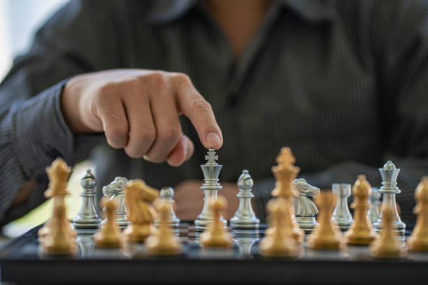 istock Businessman moving chess pieces on chess board game ideas for ideas and competitions and strategies, success, business competition planning ideas. 1407258547