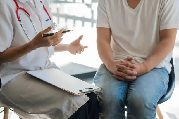 Photo of Doctors talk to patients in the clinic office. The focus is on the stethoscope and the patient consults and diagnoses, sits and talks. at the table near the window in hospital medical concept