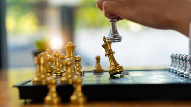 istock Businessman moving chess pieces on chess board game ideas for ideas and competitions and strategies, success, business competition planning ideas. 1407258742