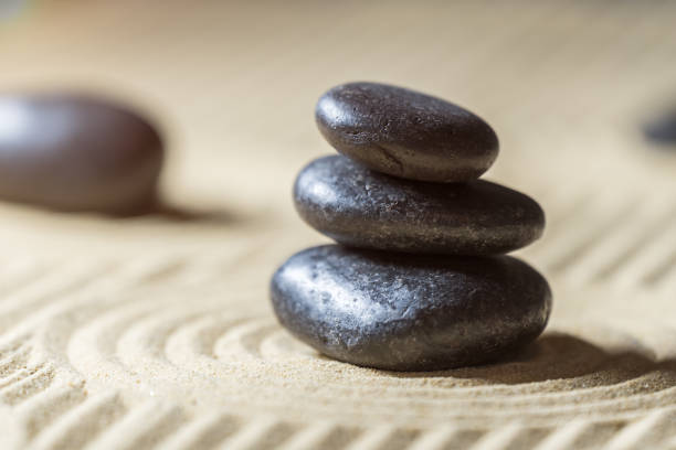 istock Zen garden with stacked stones on sand. 1407259049