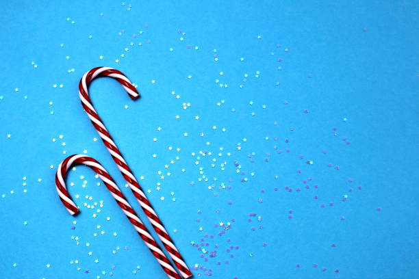 istock Sweet lollipop on a blue background studded with small stars. 1407259468