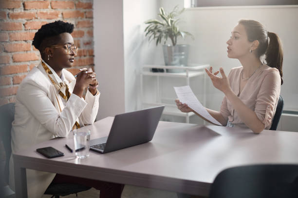 istock Young woman communicating with African American human resource manager while applying for job at corporate office. 1407260143