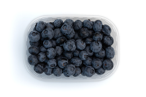 fresh blueberries in plastic box container isolated on white background, top view