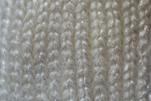 Texture of thick white woolen knitted fabric