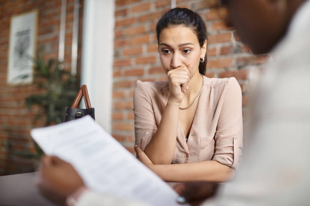 young woman feeling uncertain during job interview in the office