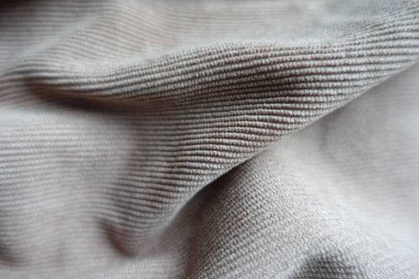 Macro of soft folds on simple gray corduroy fabric Macro of soft folds on simple gray corduroy fabric unprinted stock pictures, royalty-free photos & images
