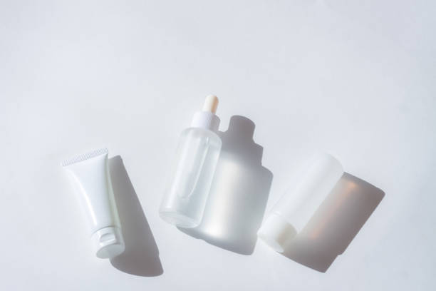 istock Cosmetic bottles with shadow on white wall background 1407260801