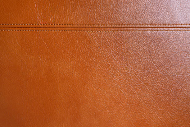 istock Brown leather, leatherette texture background wtih decorative stich 1407260807
