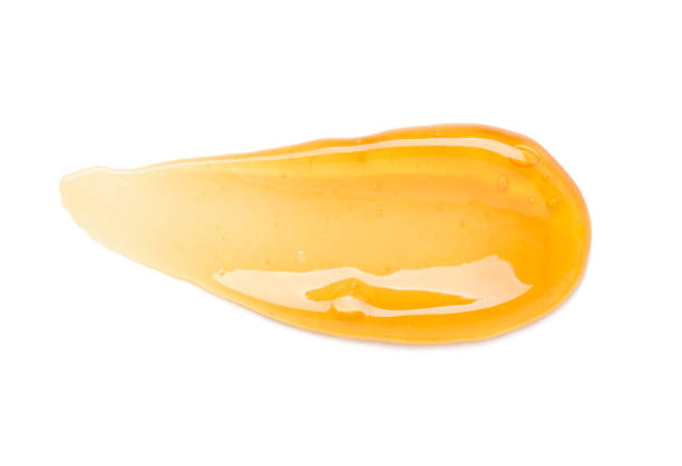 istock Clear orange gel smear with bubbles isolated on white 1407261890