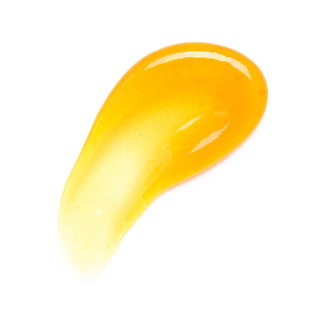 istock Transparent yellow gel cream smear smudge with bubbles macro isolated 1407261999