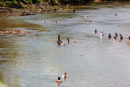 With blazing hot temperatures and low water levels groups of people go swimming in the Wolf River to escape the heat wave in Memphis, Tennessee. On July 4th, 2022.  Photo by Derek Broussard