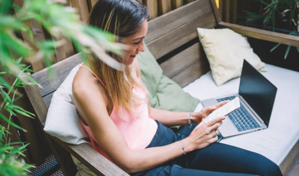 istock Positive woman using smartphone on terrace 1407264656