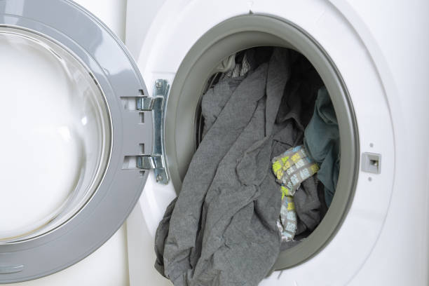 istock Open drum of washing machine with clean laundry. 1407264668