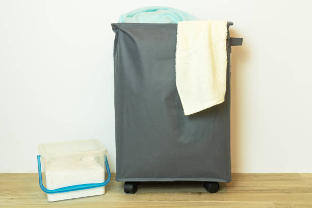 istock Textile basket with dirty laundry and washing powder in container. 1407264690