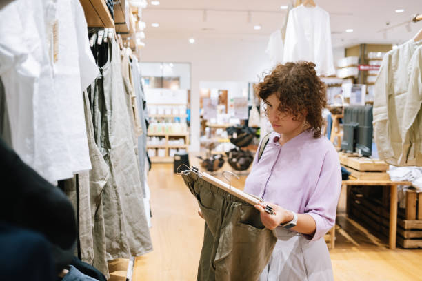 istock Woman Shopping In A Cloth Store 1407268151