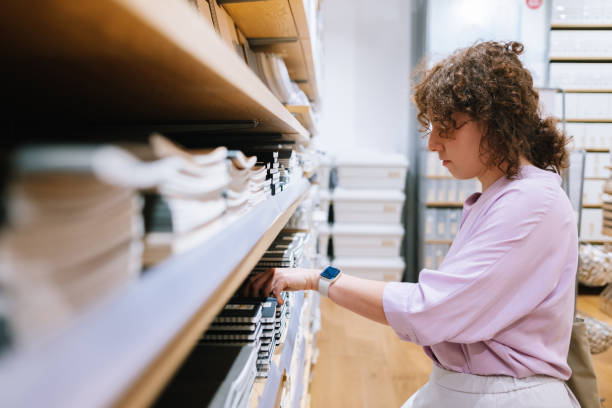 istock Woman Looking For A Notebook To Buy 1407268154