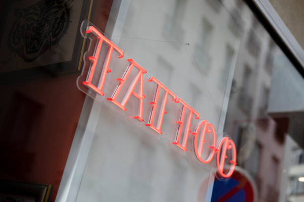 istock Illuminated tattoo sign in a shop window 1407268293