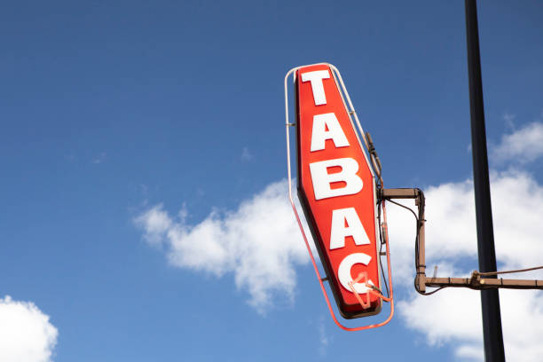 istock Tobacconist sign against a blue and cloudy sky with copy space 1407268909