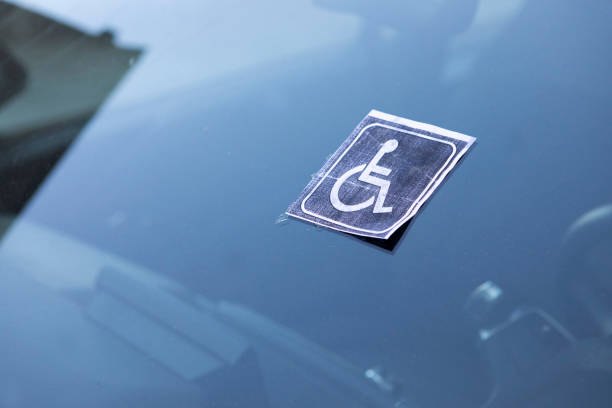 Unofficial disabled person sign on the windshield of a car confirming the right of disabled car owners to benefits
