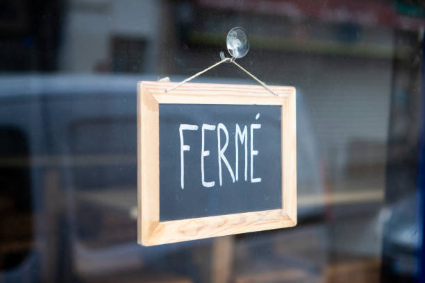 istock Closed sign hanging on a glass doorway 1407268930