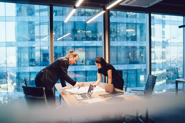 istock Pensive diverse colleagues working on paper draft in office 1407268944