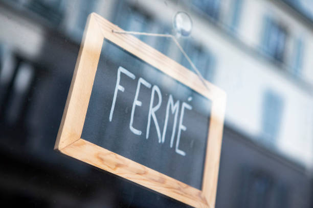 istock Closed sign hanging on a glass doorway 1407268947