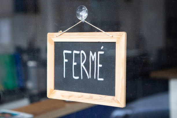 istock Closed sign hanging on a glass doorway 1407268950