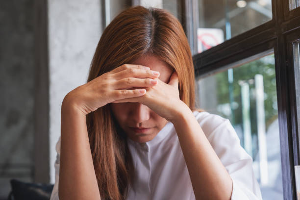 istock A young woman with feeling sad and stressed, sick and headache 1407269411