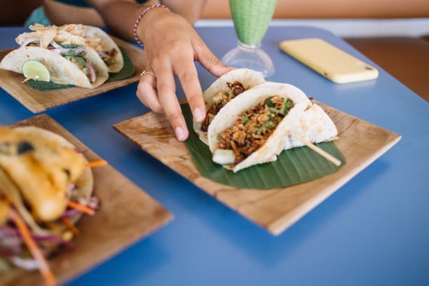 istock Crop female eating beautifully served tacos 1407271090