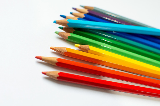 A closeup shot of colorful pencils in a shade sequence from the brightest to the darkest