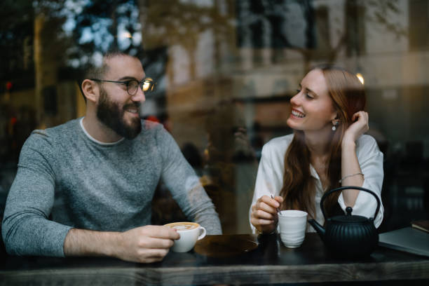 istock Smiling couple having break in cafeteria 1407272904