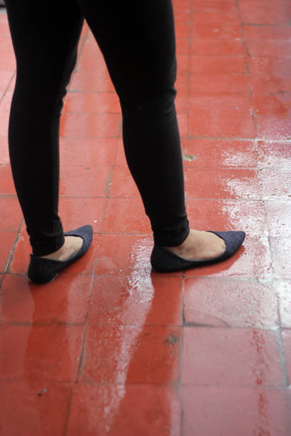 istock Girl walking at wet floor 1407273054