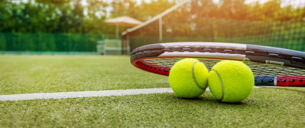 tennis racket and balls on synthetic grass outdoor court. banner with copy space - tennis court tennis ball racket imagens e fotografias de stock