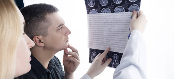 istock Epileptologist examines patient MRI and electroencephalogram. Concept treating epilepsy and helping people who suffer from this disease. Neurologist at work. Pathology of the brain. Seizure activity 1407275526