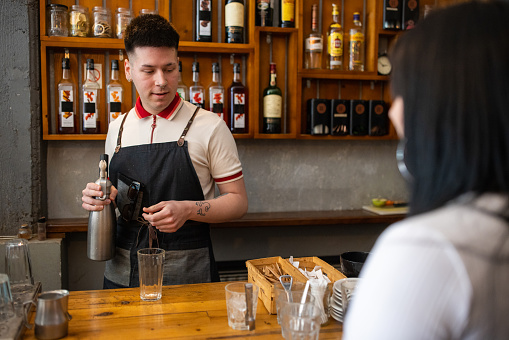 Young Caucasian female and male colleagues working at the coffee shop