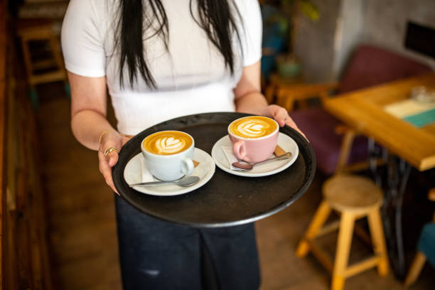 istock Unrecognizable waitress carrying tray with coffee 1407275569