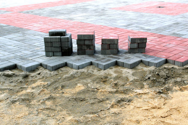 istock Road works, laying paving stones on the sand. 1407278129