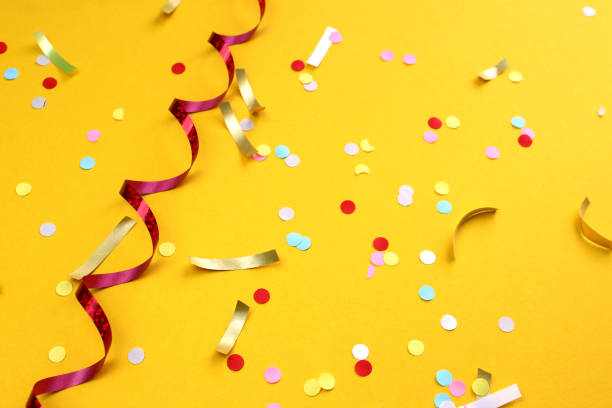 istock Festive background with confetti on a yellow background. 1407282873