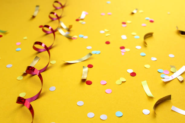 istock Festive background with confetti on a yellow background. 1407282874