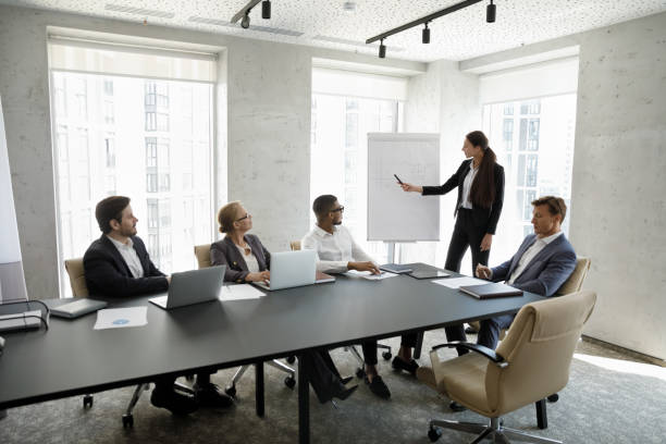 Business trainer lead educational seminar for multi ethnic company staff