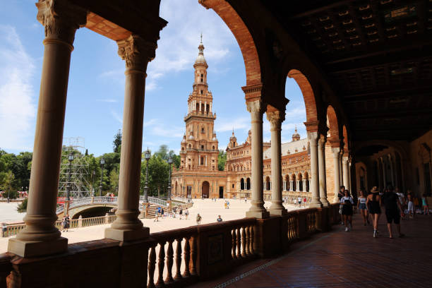 Tourists visiting the Plaza de España in Seville, Spain, Europe. Built in 1928, it has now been adapted for use as offices for government agencies stock photo