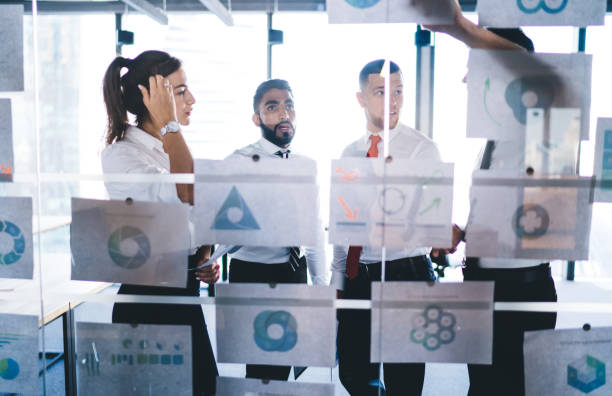 istock Group of multicultural colleagues analyzing corporate revenue during together cooperation on business project, successful male and female experts talking about graph charts and financial documents 1407284213