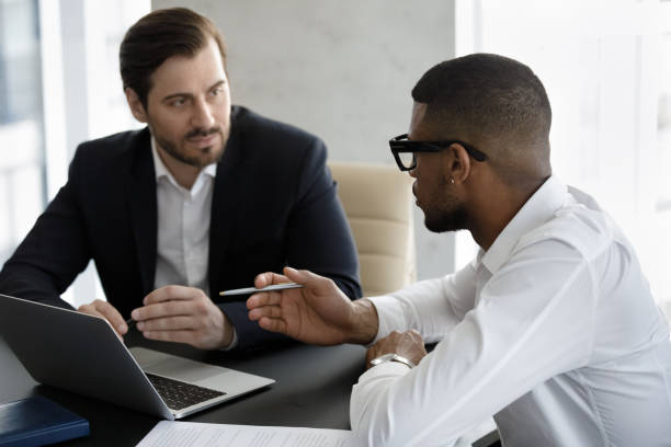 istock Two diverse businessmen negotiating in modern office during meeting 1407284265