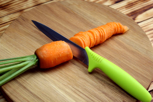 istock Carrot sliced with a knife lies on a cutting board. 1407285031