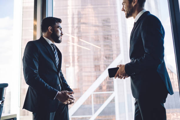 istock Confident diverse colleagues discussing business project 1407285383
