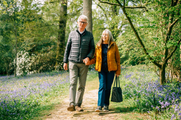 istock Senior couple walking together in nature 1407285476