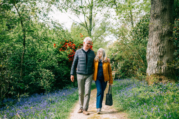 istock Senior couple walking together in nature 1407285550
