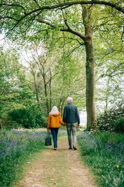 istock Senior couple walking together in nature 1407285552